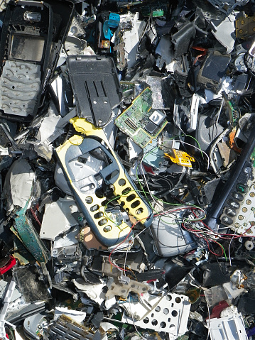 Pile of old electronics and mobile phones in a recycle facility