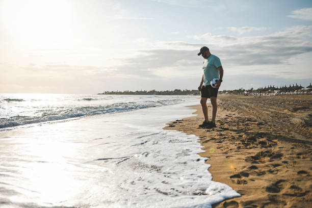 istock Man walking and doing sports on the beach 2061061810