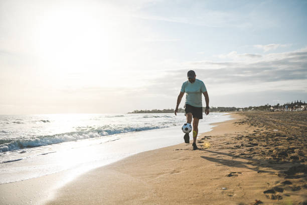 istock Man walking and doing sports on the beach 2061066075