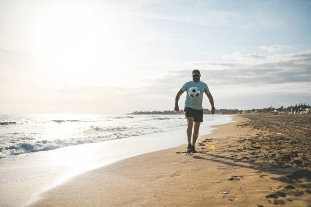 istock Man walking and doing sports on the beach 2061071341