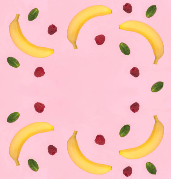 istock Banana and raspberry on the pink background. Copy space. Top view. 2061085627