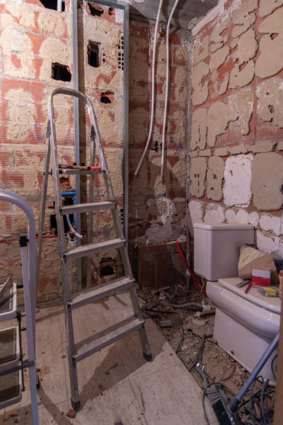 istock A bathroom undergoing renovation with peeling walls, debris on the floor, tools and a ladder with a dismantled toilet 2061100285
