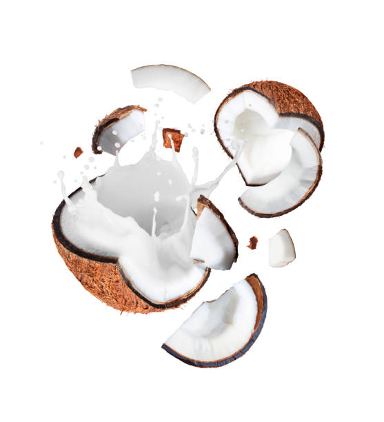 istock Crushed coconut in the air with milk splashes isolated on white background 2061103577