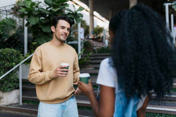 istock Happy couple standing outside a cafe talking and drinking coffee 2061103910