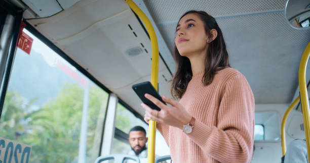 woman, bus and thinking with smartphone for travel to work for social media, news and information. female person, public transport and cellphone for online update, job and career opportunity. - young adult reading newspaper the media imagens e fotografias de stock