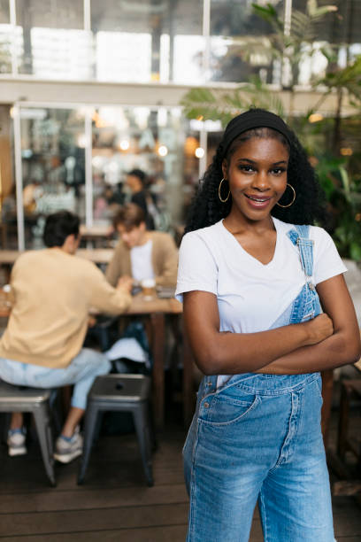 istock Fashionable woman at a cafe with people sitting at back 2061104607
