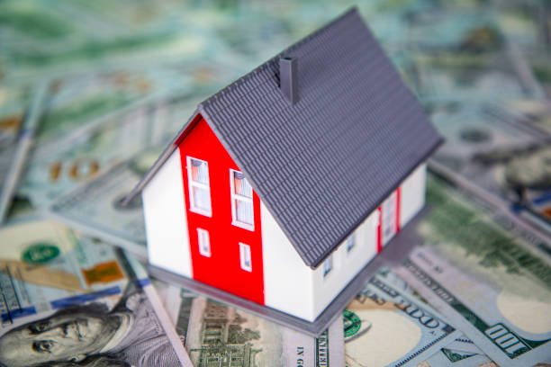 istock Model house on pile of cash 2061104881