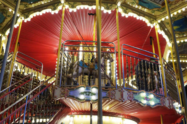 istock children's carousel with horses illuminated by garlands 2061115029