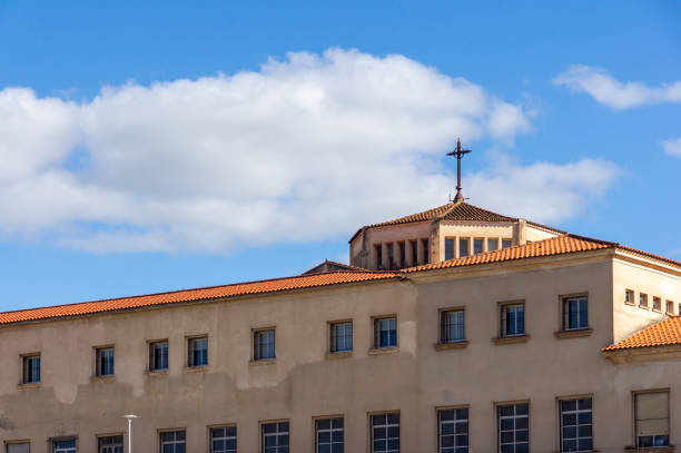 Heavenly Lantern: Cross above a blue sky and white clouds.