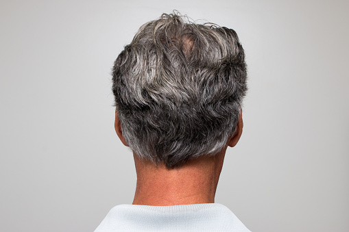 Man with graying salt and pepper hair starting to turn a bit gray
