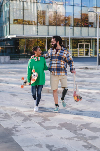 istock Two young people walking outdoors carrying the fruit in an ecological bag. Concept: lifestyle, sunset, outdoors 2061142820
