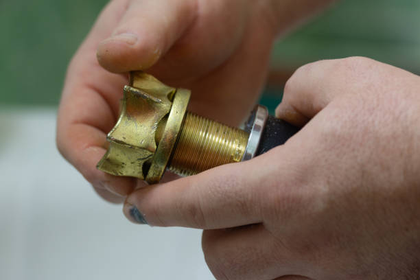 istock metal part in the crane structure in hands. 2061149029