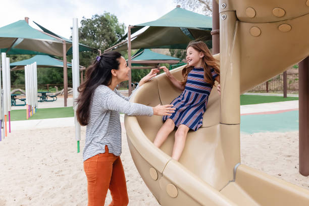 istock Mother and daughter playing on a slide 2061152656