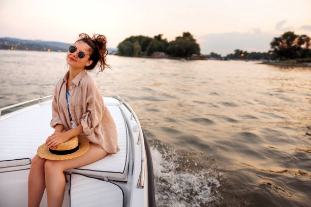 istock Woman enjoying summer vacation sailing on a boat 2061167652