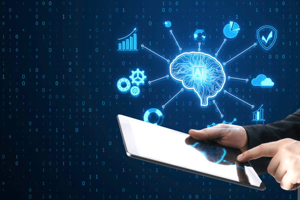 istock Close up of businessman hands holding and using tablet with creative glowing digital brain hologram on blurry background. AI and futuristic hud elements. 2061177015
