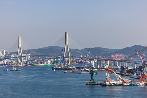 busan, south korea - november 1, 2023: harbor bridge and industrial harbor in busan city, south korea.