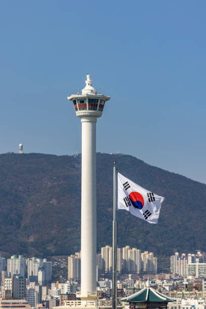 daimond tower (busan tower) with korean national flag in the wind, busan city, south korea.