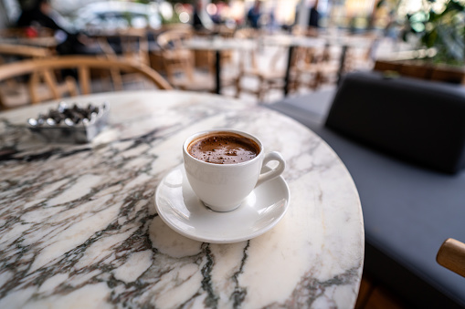 turkish coffee is foreground focus on foregroundcafe is background horizontal retail still