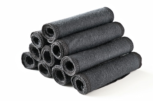 Black reusable toilet paper rolled into rolls. Washable paper towels. Zero waste cloth wipes isolated on a white background. Sustainable plastic free tissues. World environment day.