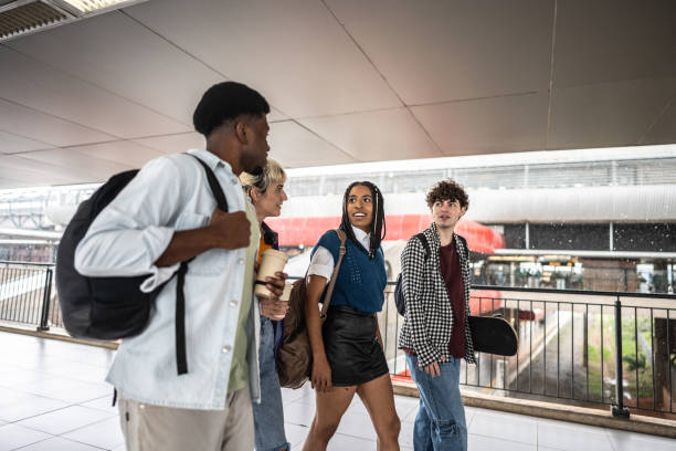 istock Friends walking and talking at subway station 2061247908