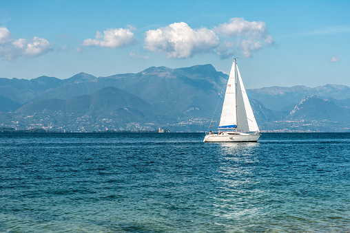A sailboat lonely on the lake Garda in Northern Italy