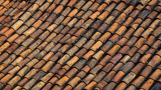 Background of old roof tiles. Roofing texture. Red corrugated tile element of roof. Seamless pattern.