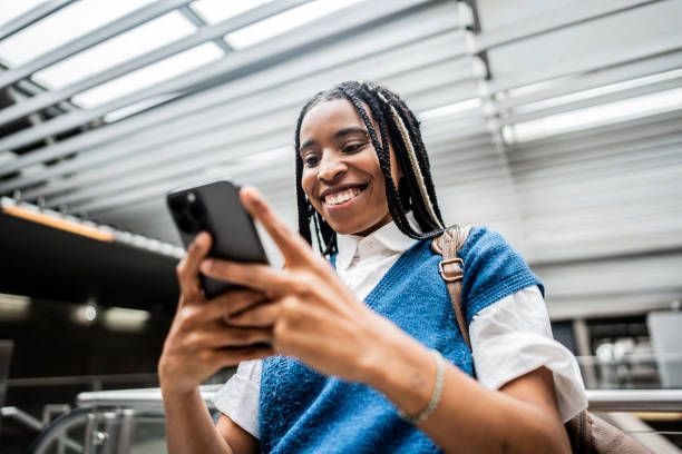 Young woman using mobile phone at subway station