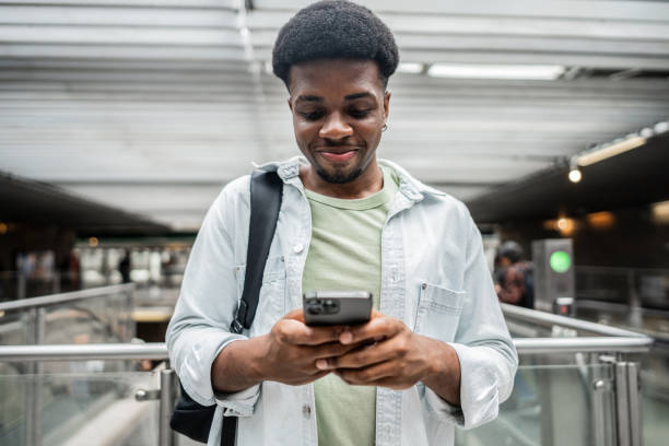 istock Young man using mobile phone at subway station 2061253691
