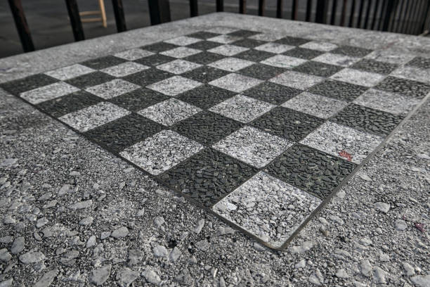 istock chessboard on a stone table in a public park (brooklyn new york city) chess board checkered squares pattern close up detail black and white game outdoors 2061262580