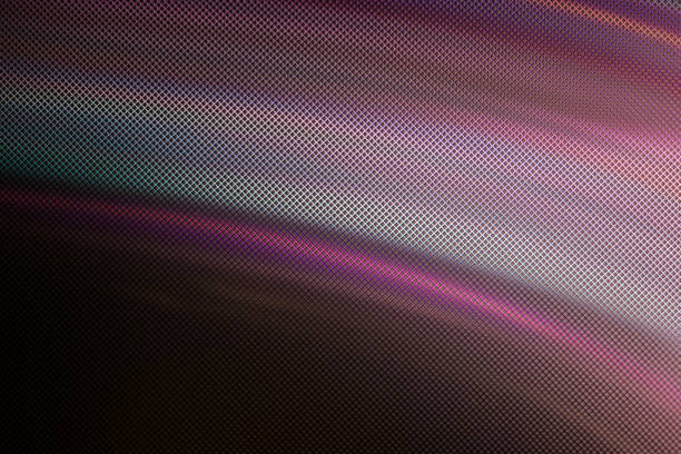 Blurred Light painting one exposure in camera with textured glass. light glares with a spectral gradient on a dark background. Multicolored abstract colorful line. Unusual light effect.