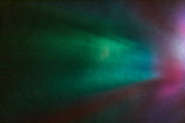 Soft Bright multicolored glare on dark rough textured cardboard. Soft rainbow light. Abstract colorful background.