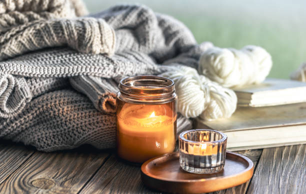 istock Home composition with burning candles, knitted elements and books. 2061288314