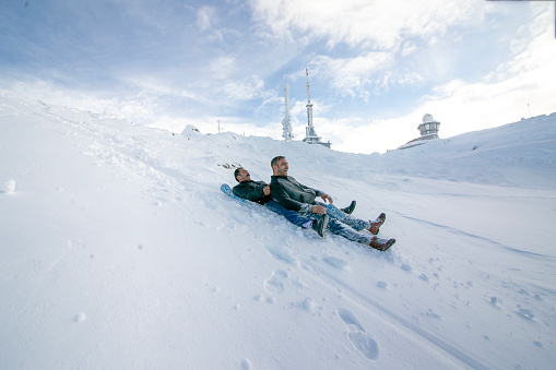 Karaman, Turkey, January 19, 2019: Men enjoying sledding in the snow in Karaman, Montenegro.