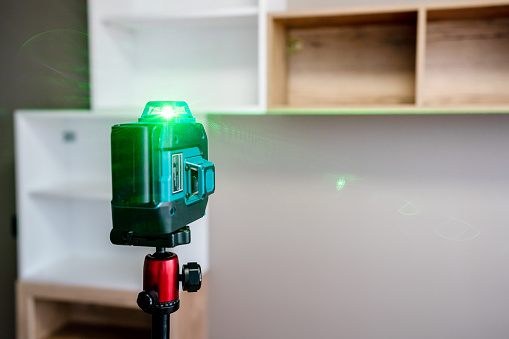 Adjusting and levelling furniture in the apartment using the professional laser level