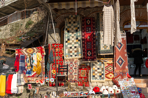 Colourful handmade textile products for sale at a craft fair in the Herastrau Park area of Bucharest, Romania. Horizontal colour image.