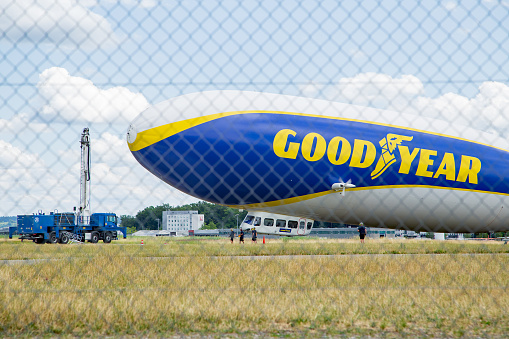 blimp flying in clear blue sky with blue copy space to advertise your message