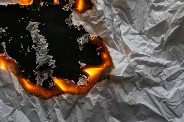 istock burning paper, glowing edge of paper 2061382811
