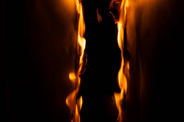 burning paper, glowing edge of paper on a black background