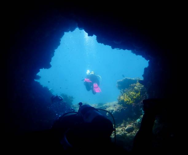 istock Scuba divers in ocean cave 2061383854