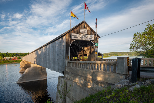 Hartland Covered Bridge front angled view  in evening light with blue sky