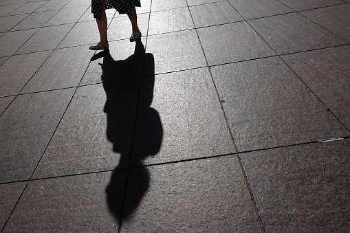 Silhouette of a man walking in a dark passage