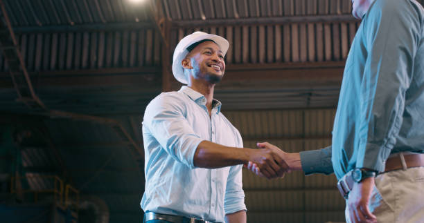 istock Onboarding, men and hard hat with engineer, handshake and maintenance project with business or thank you. Teamwork, smile or architecture with safety and industrial with feedback, review or agreement 2061480440