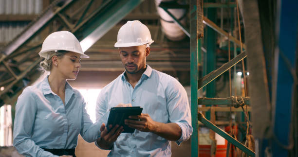 istock Business people, teamwork and tablet for electrical engineering, inspection and planning in a workshop. Project, manager and employee with tech and maintenance with industry, safety or online reading 2061481537