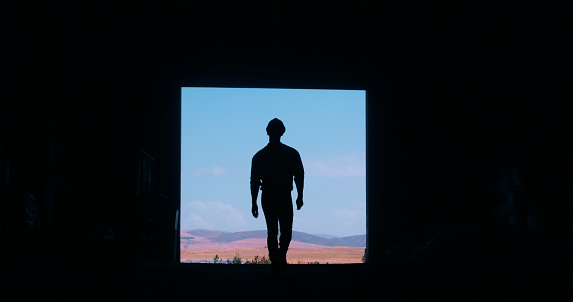 Silhouette, construction worker and back view of person on site, mockup space and maintenance labor. Architecture, engineer and black frame with contractor for renovation project or infrastructure