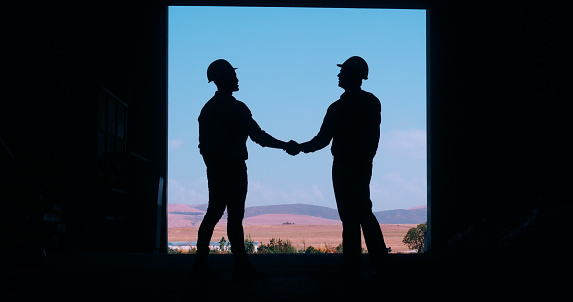 Silhouettes, men and hard hat with engineer, handshake and maintenance project with agreement or thank you. People, staff or architecture with safety or industrial with feedback, review or onboarding