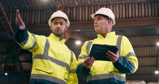 istock Quality control, tablet and men with storage, teamwork and inspection with warehouse and helmet for safety. Distribution, meeting or engineering with tech or industry with productivity or digital app 2061516154