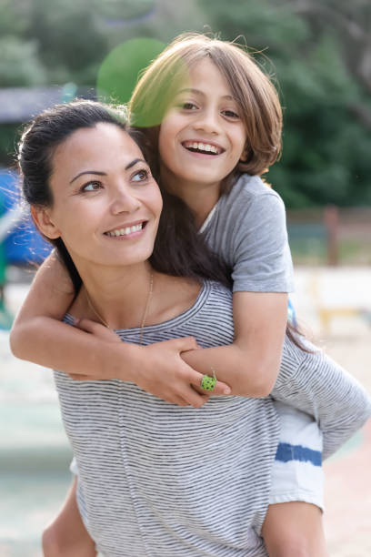 istock Surfer boy piggyback riding on his mom 2061528765