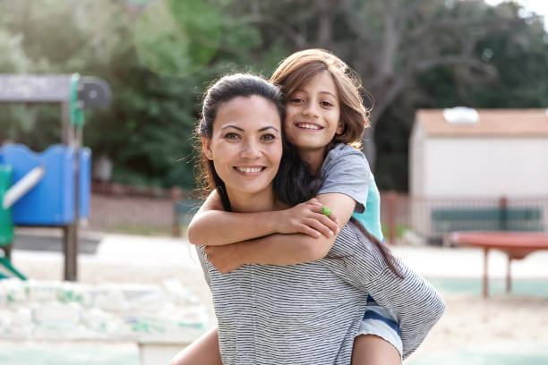 istock Surfer boy piggyback riding on his mom 2061529673