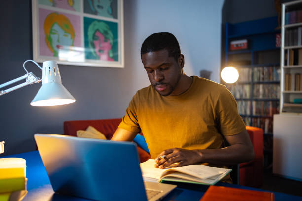 istock African American student studies at home at night 2061530852