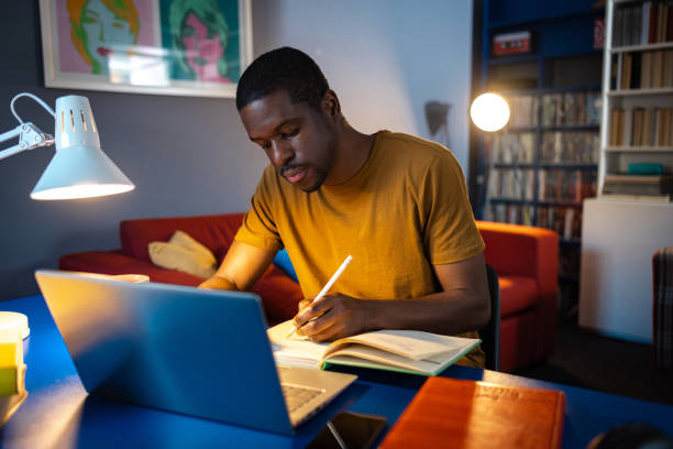 istock African American student studies at home at night 2061531902